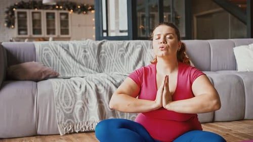 Woman Meditating at Home in Yoga Pose