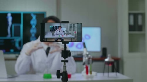 Asian Scientist Man Shooting Video With A Smartphone
