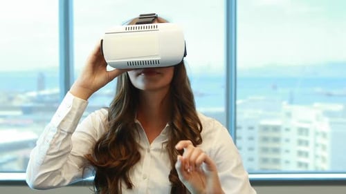 Young Woman Using Virtual Reality Headset Indoors