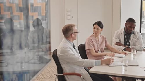 Medical Staff Discussing Information at Conference Table
