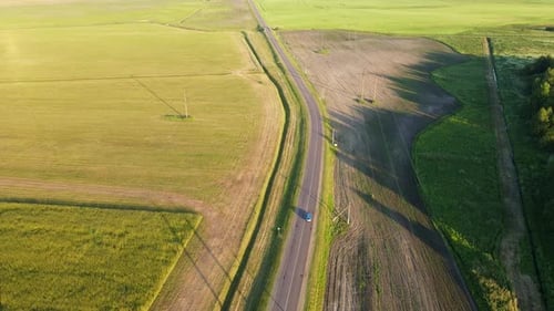 Aerial View of Car Driving on the Road at Sunset
