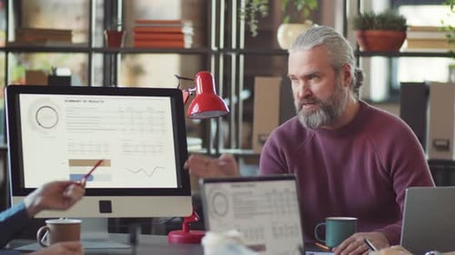 Office Meeting With Analytics Discussion and Collaboration