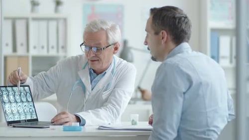 Doctor Explains Scan to Patient in Office