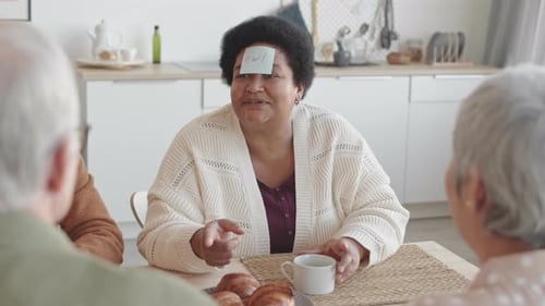 Seniors Play Guessing Game in Bright Kitchen