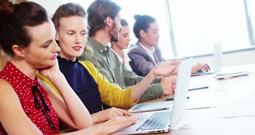 Teamwork in the Office Using a Laptop