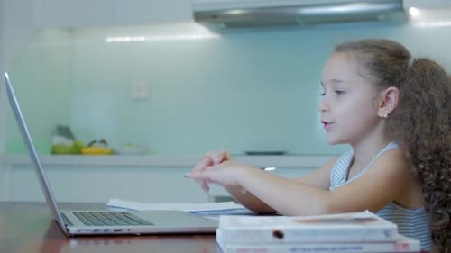 Little Girl a Cute Elementary School Child of 7-8 Years Old at Home Studying in Family Learning