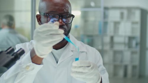 Scientist Working with Blue Liquid in Test Tube