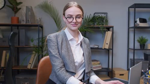 Young Adult Woman Working at Computer in Office