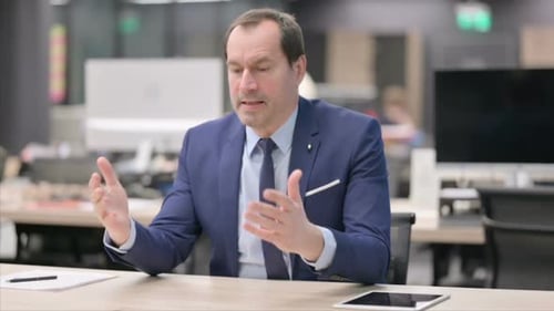 Pensive Businessman Thinking While Sitting in Office