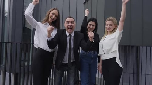 Excited Business Team Celebrates Success Outside Office