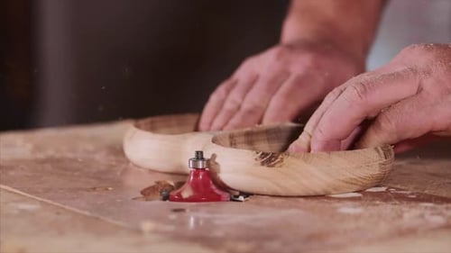 Hands Shaping Wood Bowl with Tool Close Up