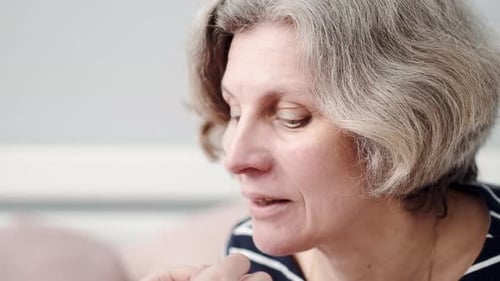 Child Applying Eye Patches to Woman's Face