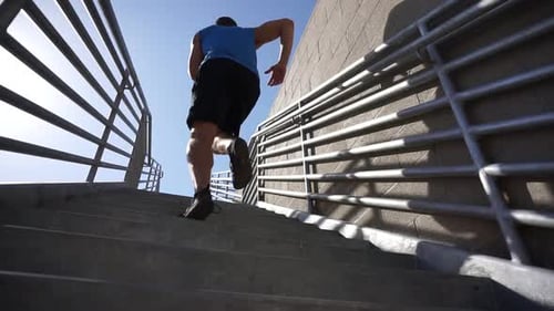 Man Running Up Stairway in the City