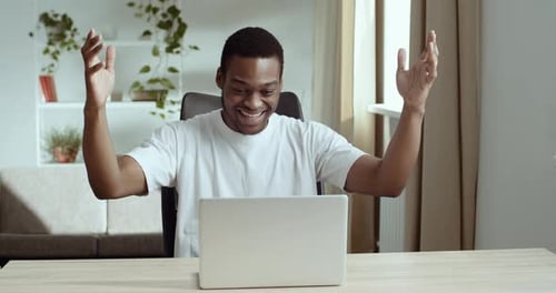 Man Celebrates Good News Using Laptop At Home