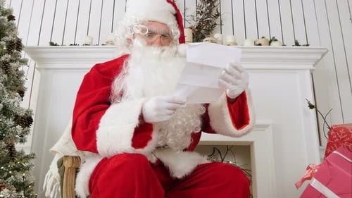 Santa Claus Reading Letter by Fireplace
