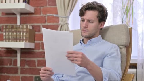Adult Reading Document Frustrated Indoors