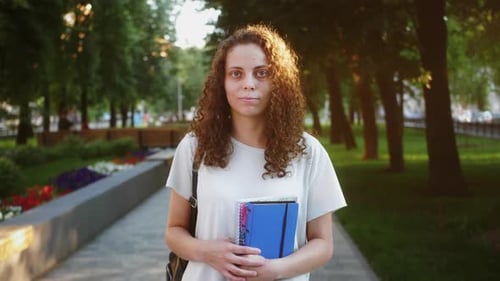 Young Adult Smiles in a Green Parkway