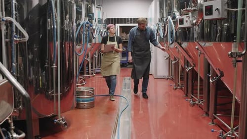 Brewery Workers Walking Along Beer Factory