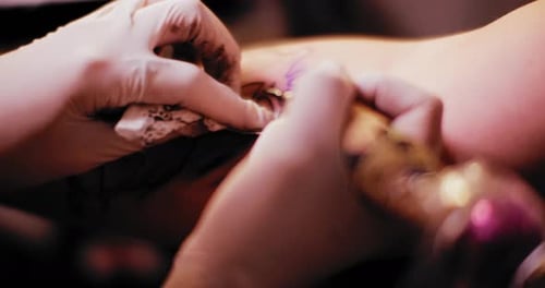 Close up of a tattoo gun, during tattoo making in a studio, macro. BMPCC 4K