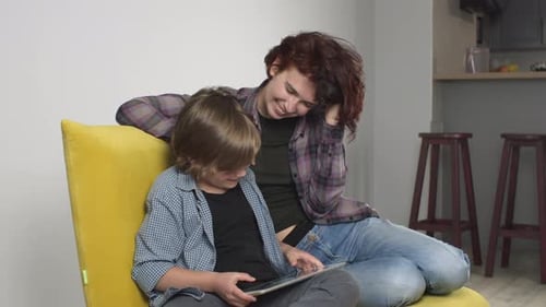 Woman and Child Using Tablet Together at Home