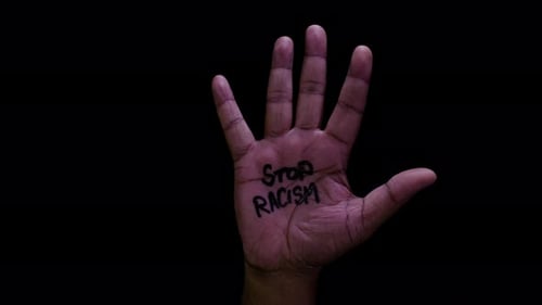 Hand Opens with Message Stop Racism
