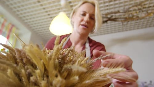 Florist Creating Dried Herb Composition
