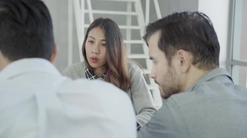 Group of casually dressed business people discussing ideas in the office