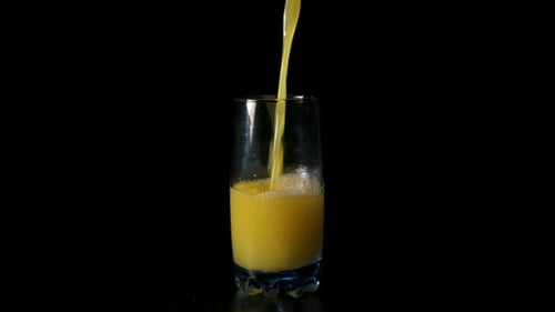 Refreshing Yellow Juice Poured into Glass