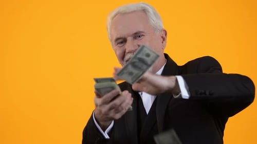 Smiling Man in Tuxedo Tossing Money