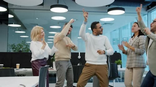 Happy Arab Man Dancing with Multi-ethnic Froup of Colleagues in Shared Office