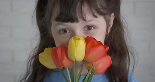 Close Up of a Child With Tulips