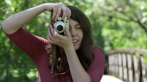 Woman Photographs With Vintage Camera in Green Park