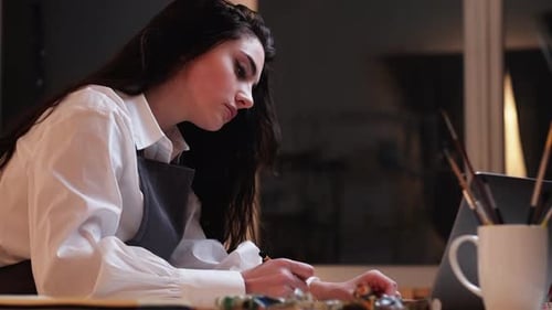 Attractive Young Woman Drawing Art at Desk