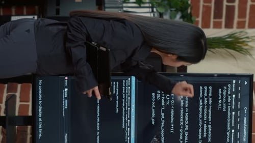 Woman Inspects Computer Code on Monitor Screens