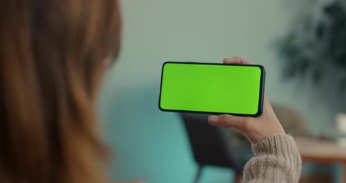 Close Up of Smartphone with Green Screen in Female Hand