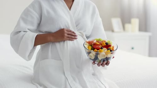 Pregnant Woman Holding Bowl of Fresh Fruit