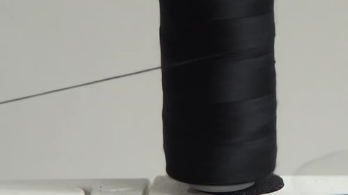 Sewing machine winding thread onto a spool.