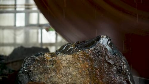 Large Industrial Stone Cutter Cuts Granite Rock Into Plates in Jets of Water Close Up