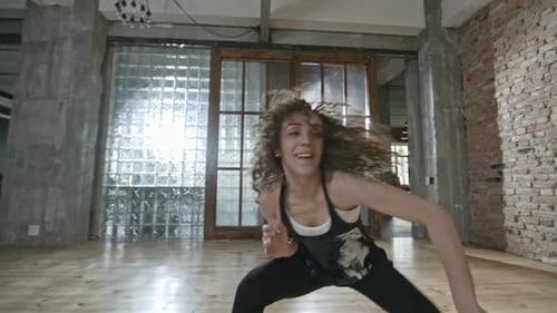 Energetic Woman Dancing in Loft