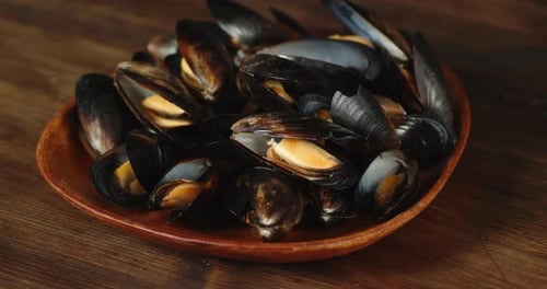 Close-up of Delicious Cooked Mussels in Wooden Bowl
