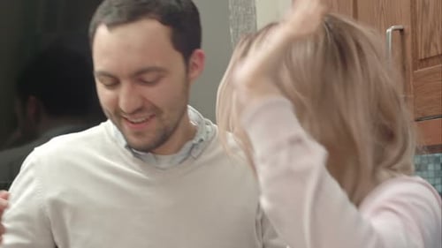 Affectionate Young Couple Conversing in Home Kitchen