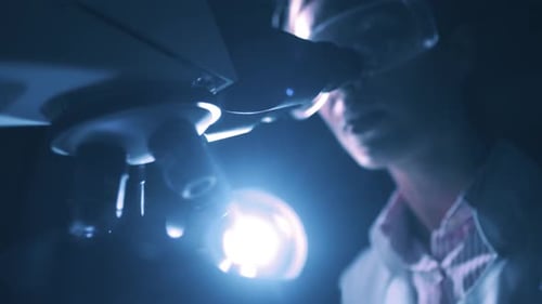 Woman Scientist Is Looking Into Microscope Biochemical Research