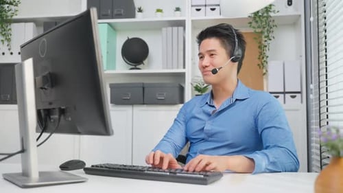 Asian businessman use laptop computer video call with office colleague.
