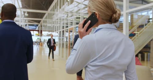 Business People Walking and Talking in Modern Office