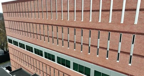 Brick office building. Rising aerial establishing shot. Red brick government workplace in USA.