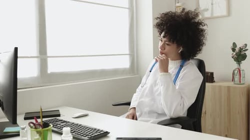 Doctor Consulting Via Video Call Holding X-Ray