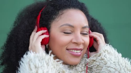 Woman Enjoying Music Wearing Red Headphones, Close-up