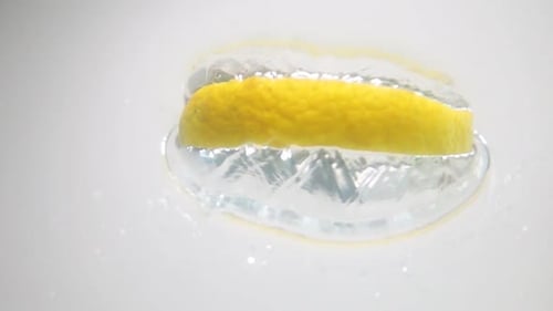 Lemon Slice Splashing Into Clear Water