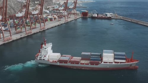 A Containerized Cargo Ship Enters the Port for Unloading