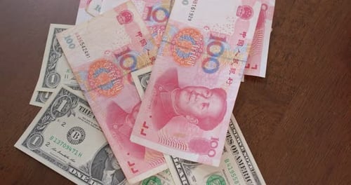 US Dollars and Chinese Yuan on Table